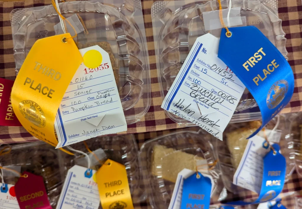 Second and First place ribbons on plastic clamshells holding quickbread slices.