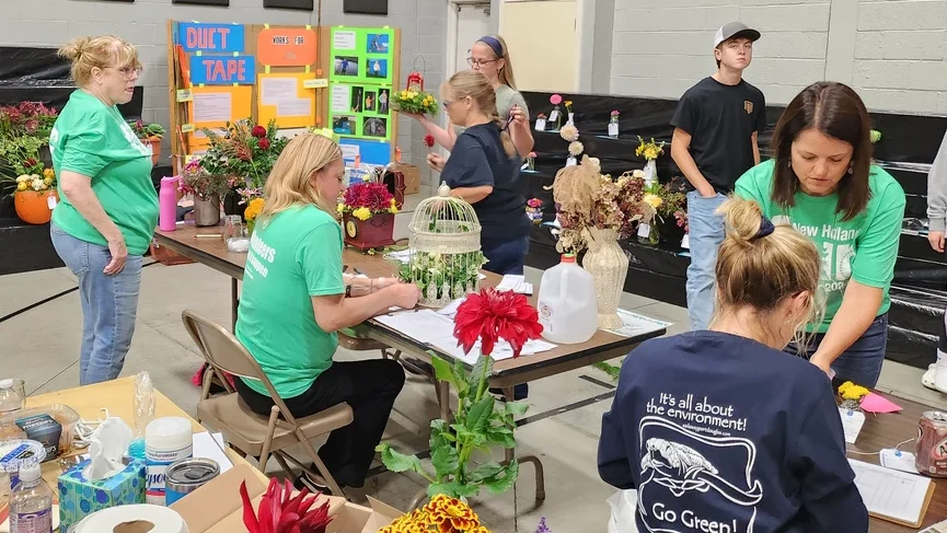 Volunteers coordinate floral exhibits.